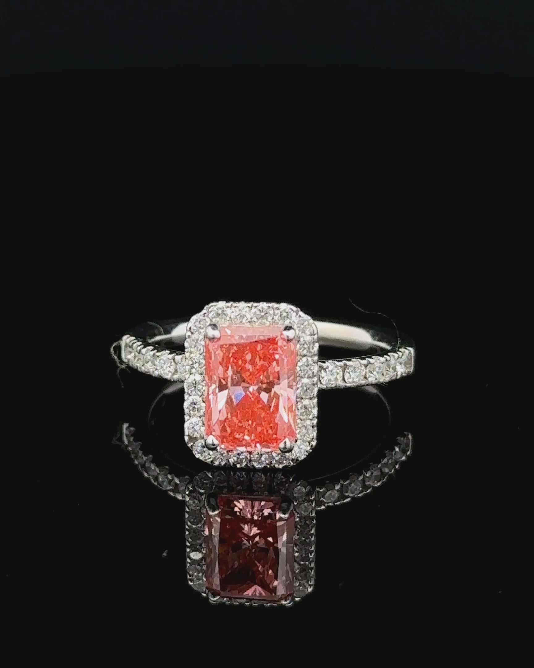 1.71 carat radiant fancy vivid pink halo lab grown diamond statement ring in 14K white gold.
